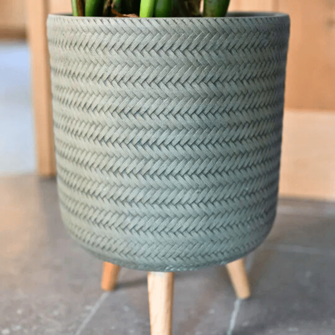 Fenne woven planter mint Fenne woven planter on legs in dry green and black, handcrafted from sustainable materials for indoor use