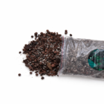 Premium aroid potting mix with chunky bark, LECA clay balls and perlite spilling from a clear branded bag onto a white background.