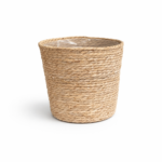 Large handwoven natural seagrass plant basket with plastic lining on white background.
