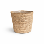 Extra large natural seagrass woven plant basket with plastic lining on white background.