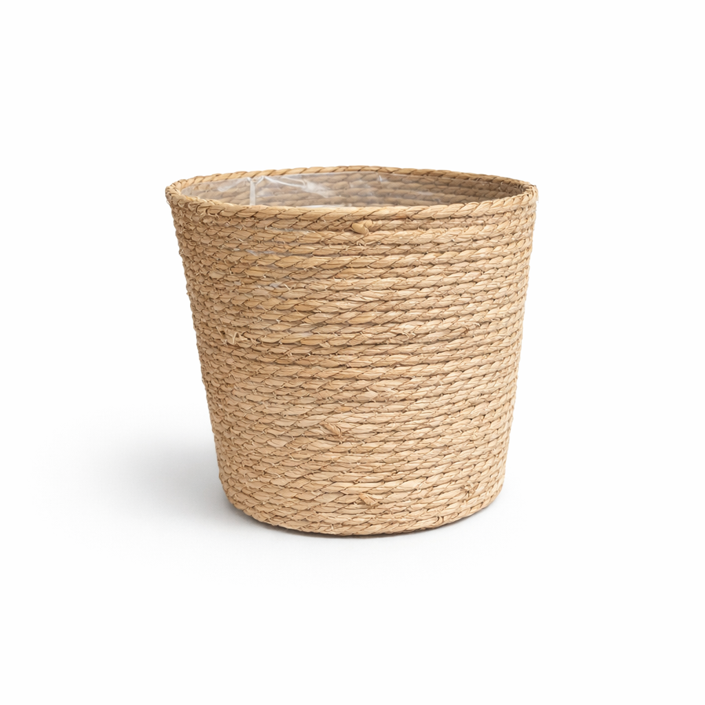 Seagrass XL Extra large natural seagrass woven plant basket with plastic lining on white background.