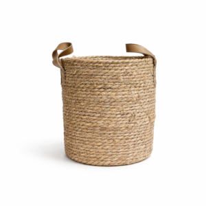Large natural seagrass woven basket with brown handles and plastic lining on white background.