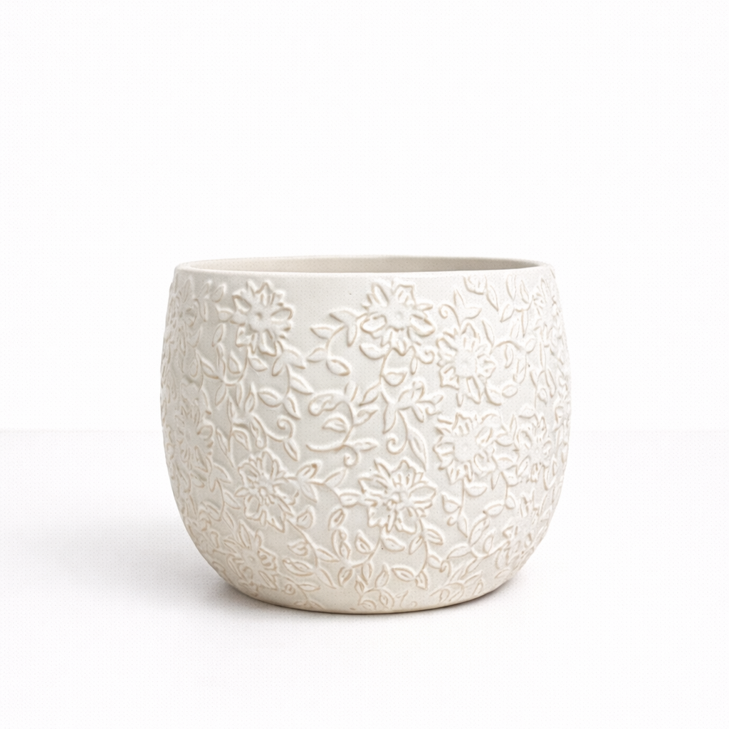 White pot L White ceramic planter with embossed floral pattern detailing on a white background.